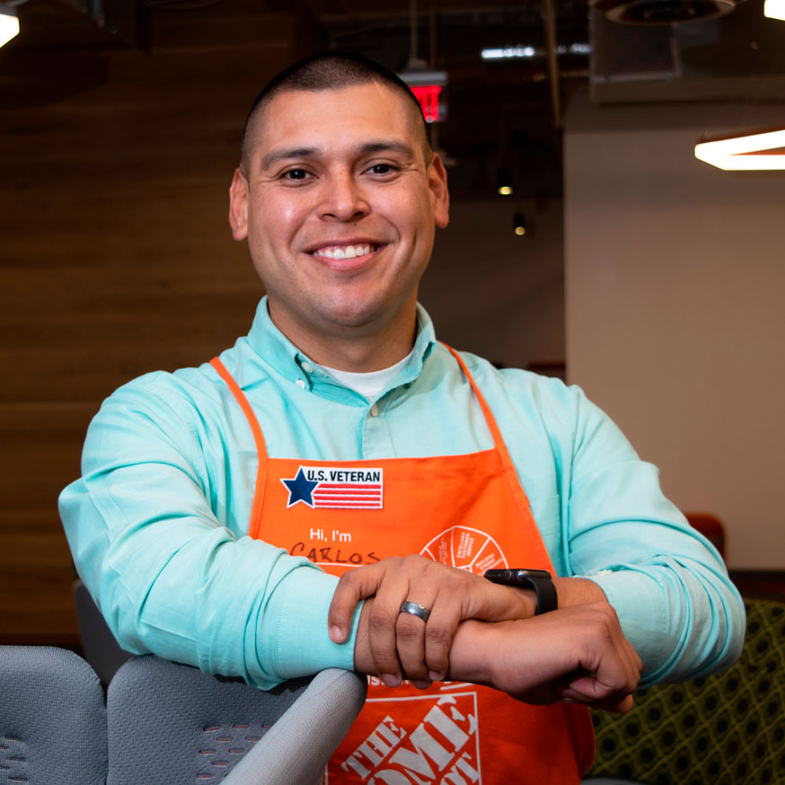Man in Home Depot apron smiling at camera